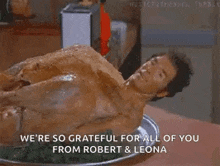 a naked man laying on top of a turkey on a plate